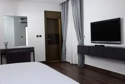 Bedroom at Magnolia with a wall-mounted television and dressing area